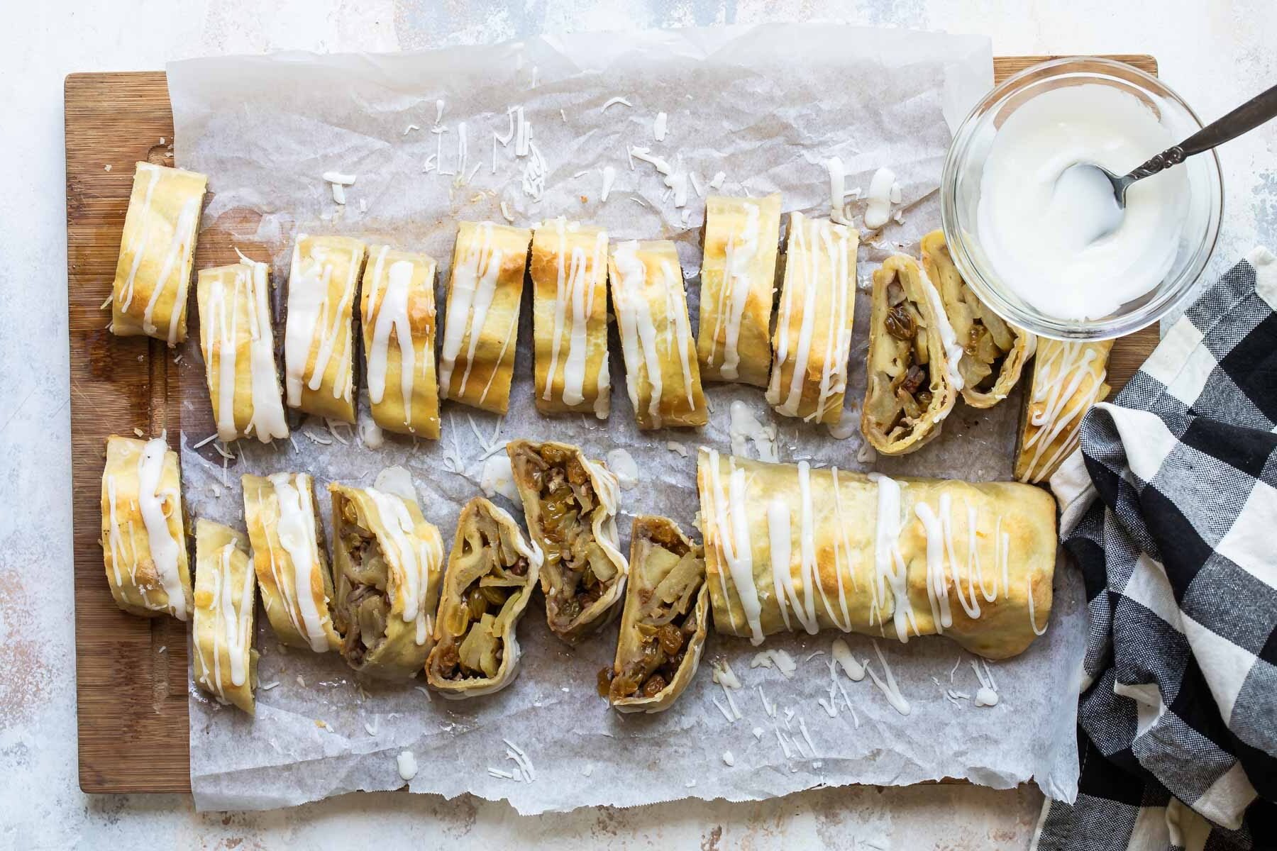 Two apple strudels on a baking sheet.