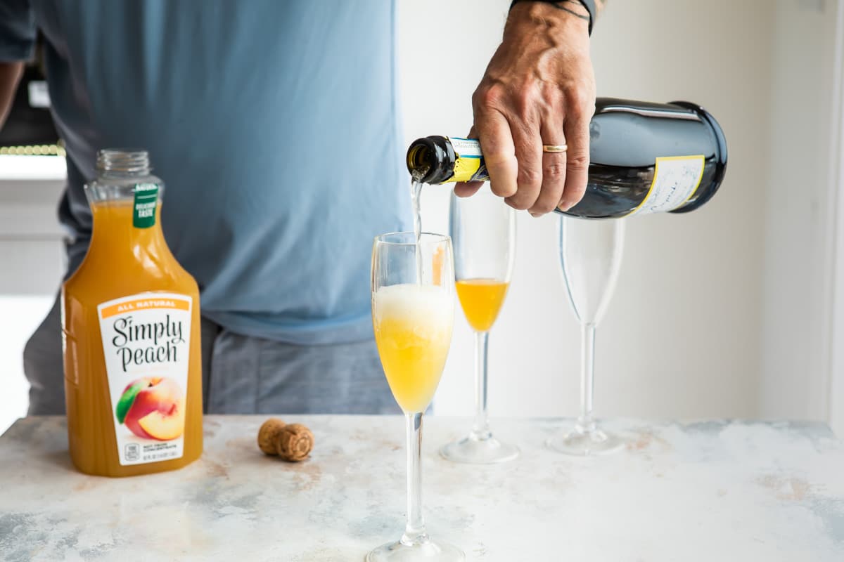 Making a bellini in a fluted glass.