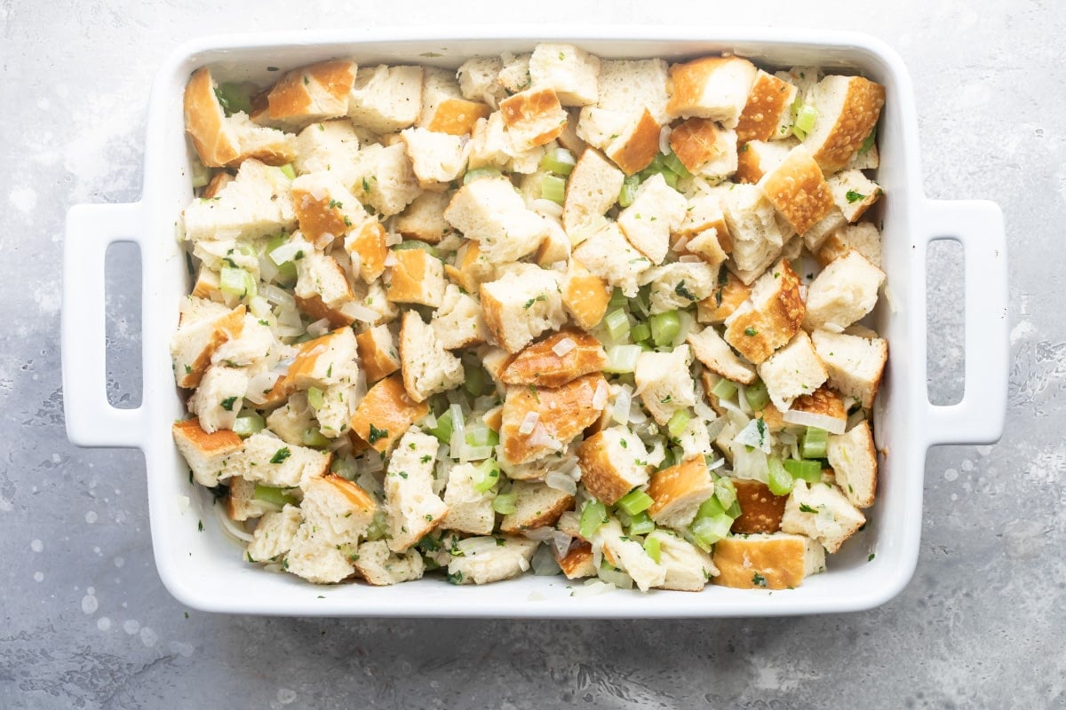 Bread stuffing in a baking dish before being baked..