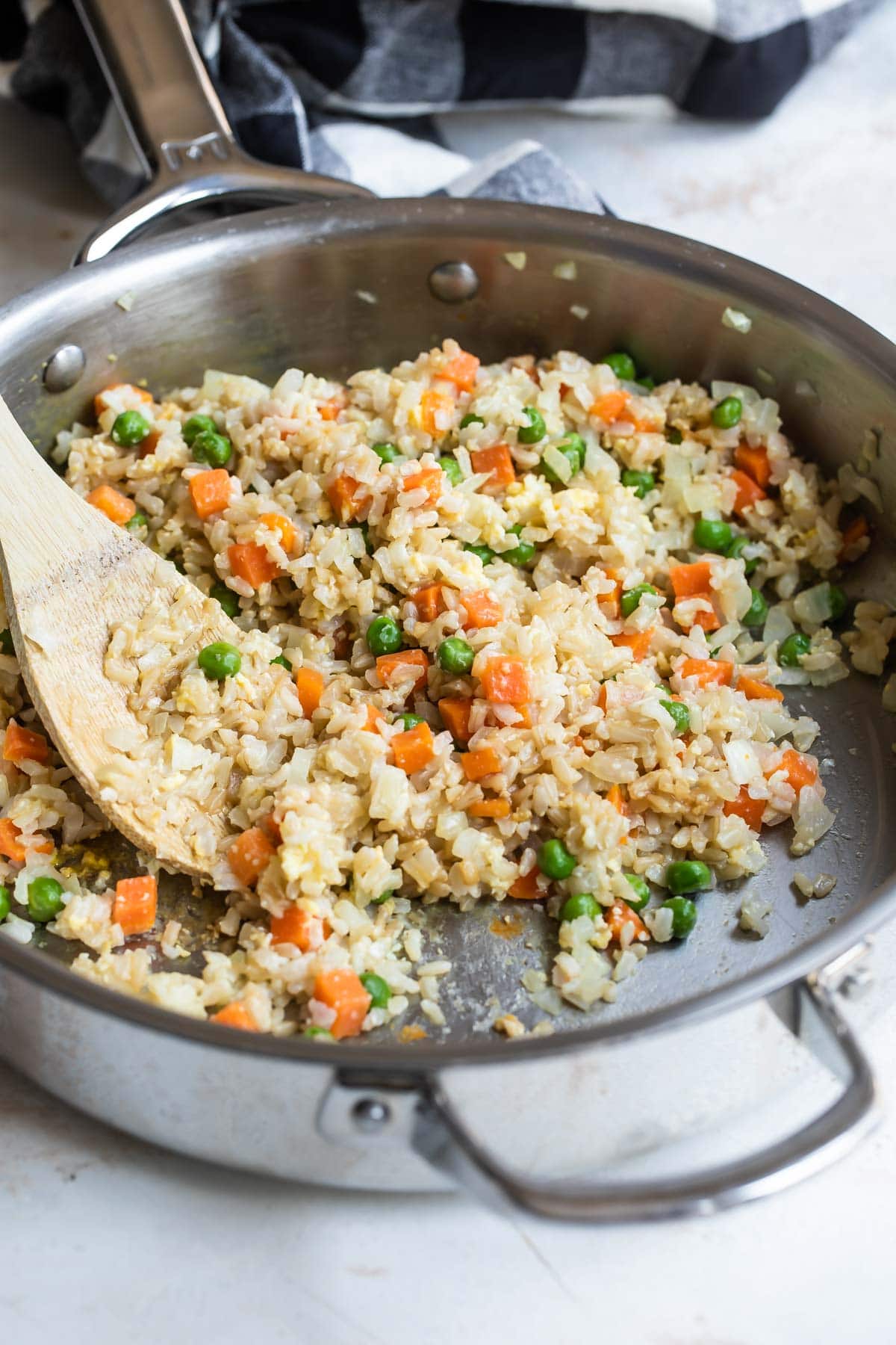 Brown fried rice in a silver skillet.