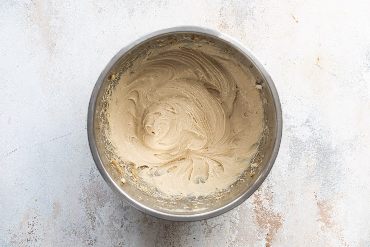 Caramel apple dip in a silver mixing bowl.