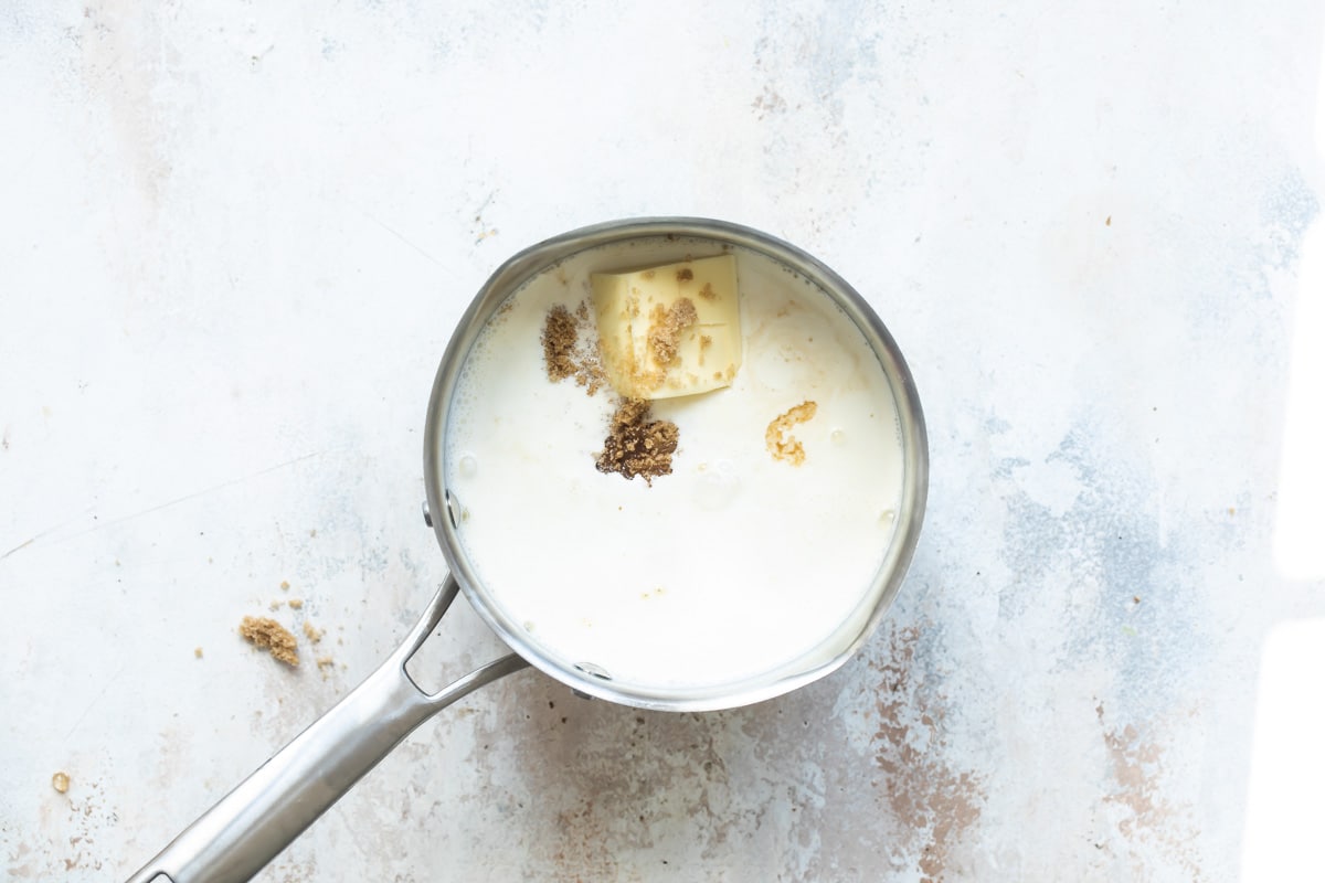 Ingredients for caramel in a small silver saucepan.