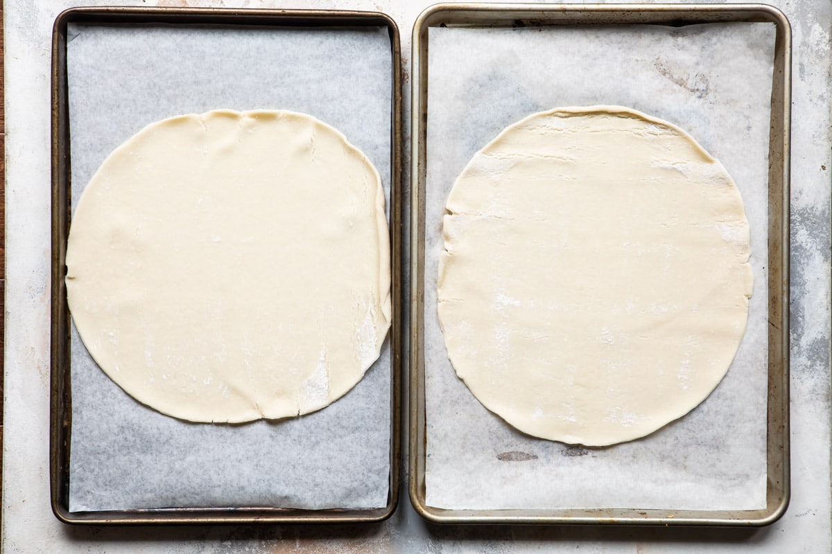 Dough on two cookie sheets for cranberry cheesecake galette.