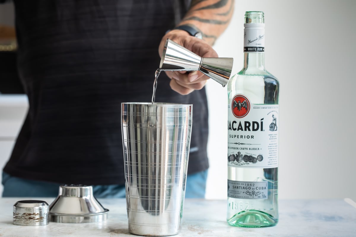 Mixing a daiquiri in a cocktail shaker.