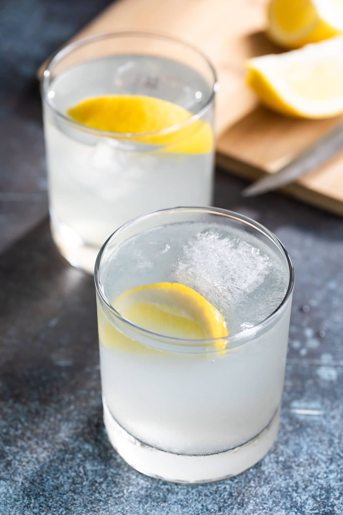 2 gin fizzes garnished with lemon slices.