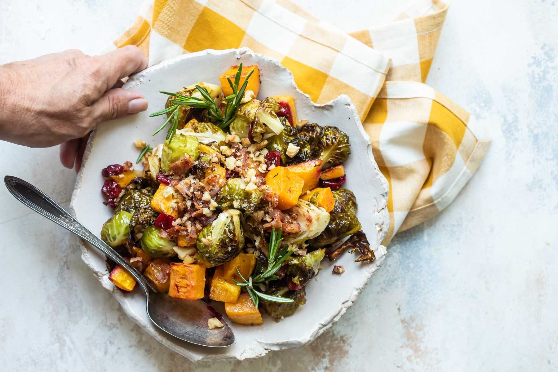 A serving of harvest roasted vegetables on a white plate.