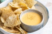 Tortilla chips next to homemade cheese sauce.