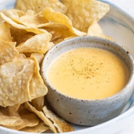Tortilla chips next to homemade cheese sauce.