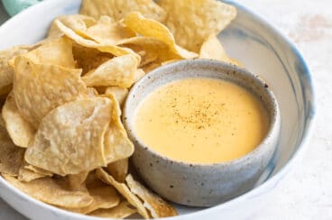 Tortilla chips next to homemade cheese sauce.