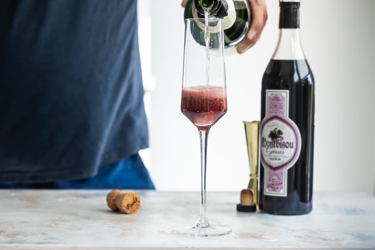 Mixing a Kir Royale in a fluted glass.