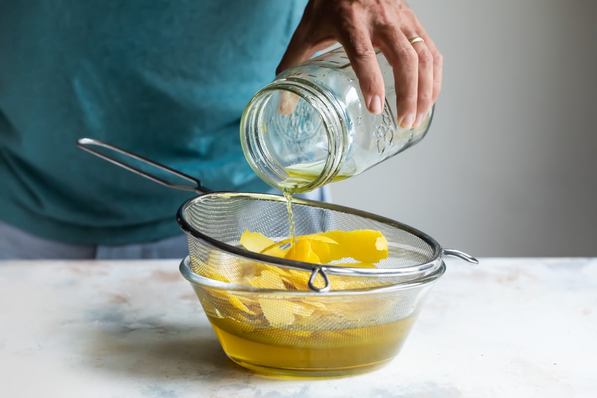Straining the peels out of limoncello.