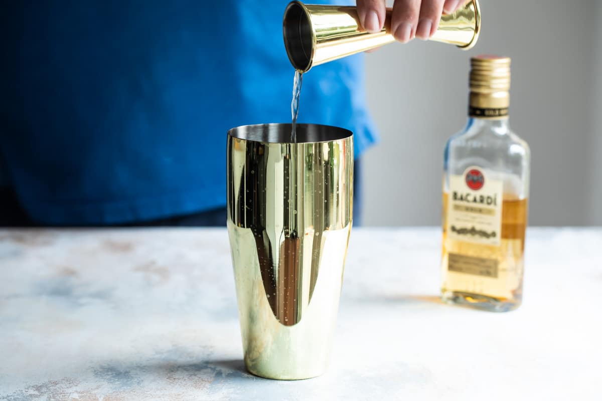 Mixing a Mai Tai cocktail.