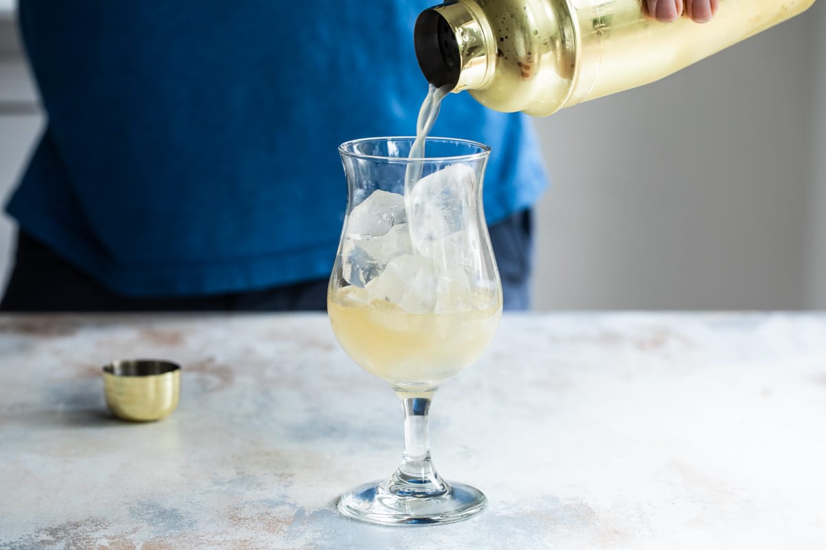 Mixing a Mai Tai cocktail.