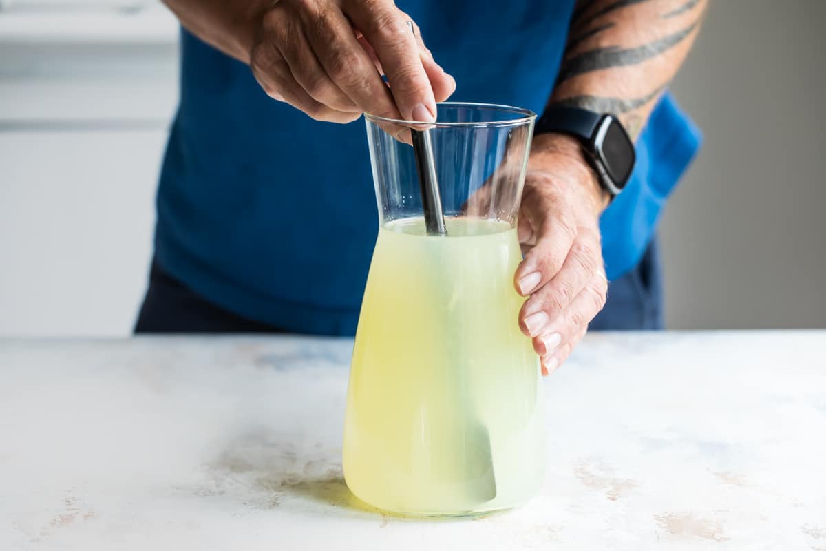 Stirring up a pitcher of margaritas.