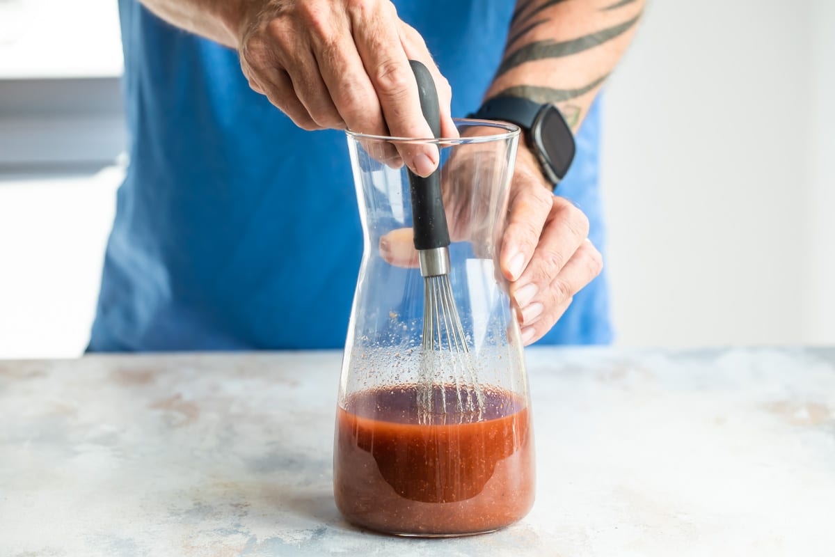 Mixing Michelada mix in a pitcher.