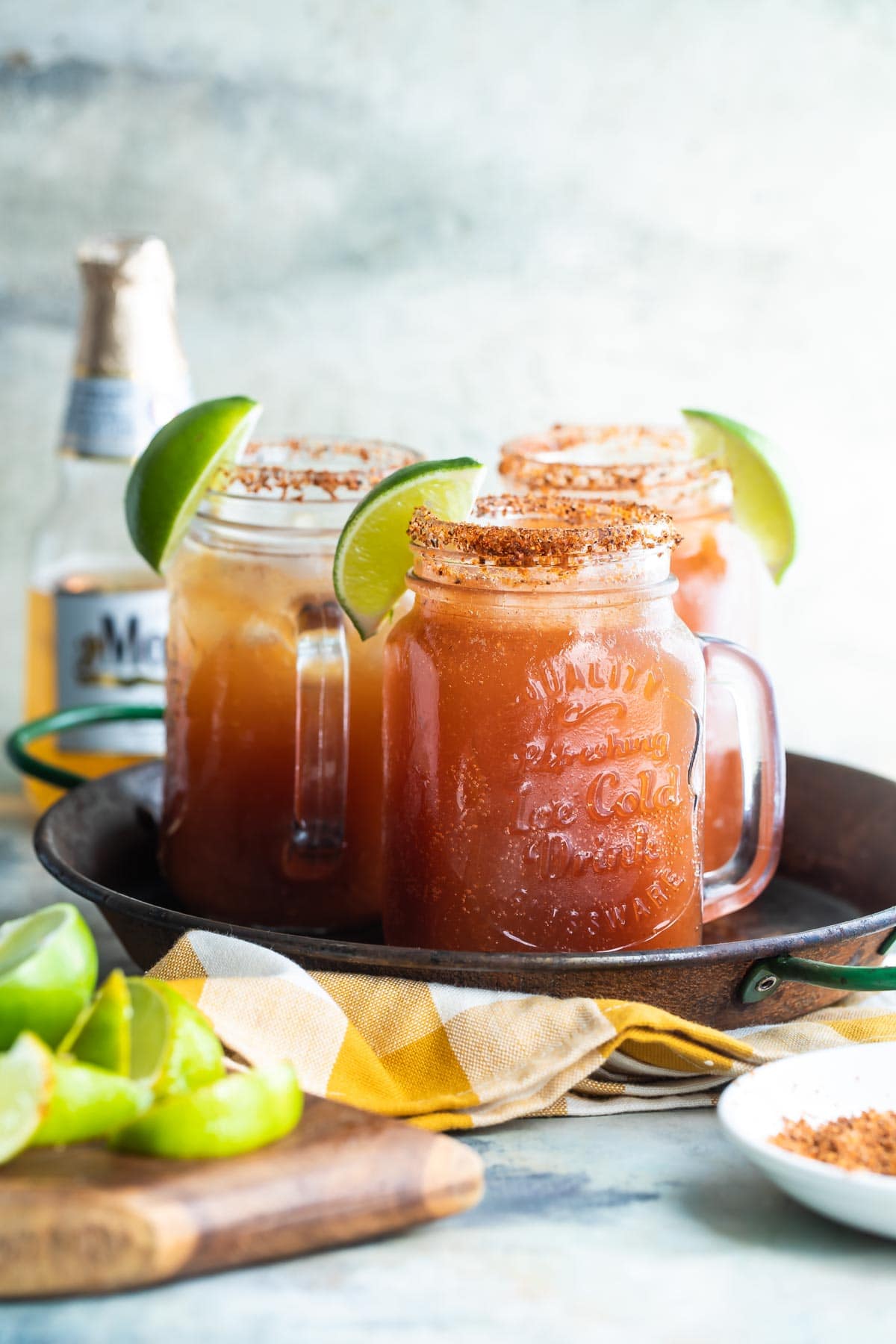 3 Micheladas on a metal tray.