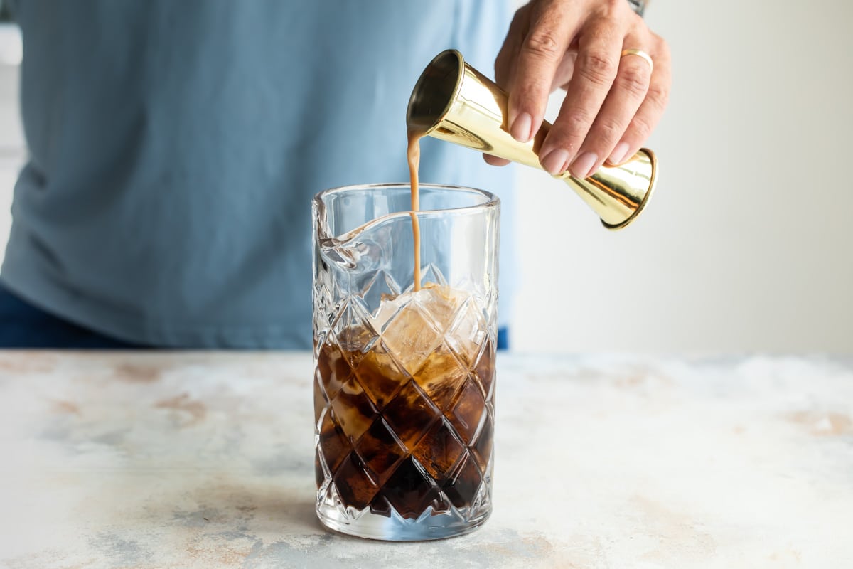 Mixing a mudslide in a cocktail glass.