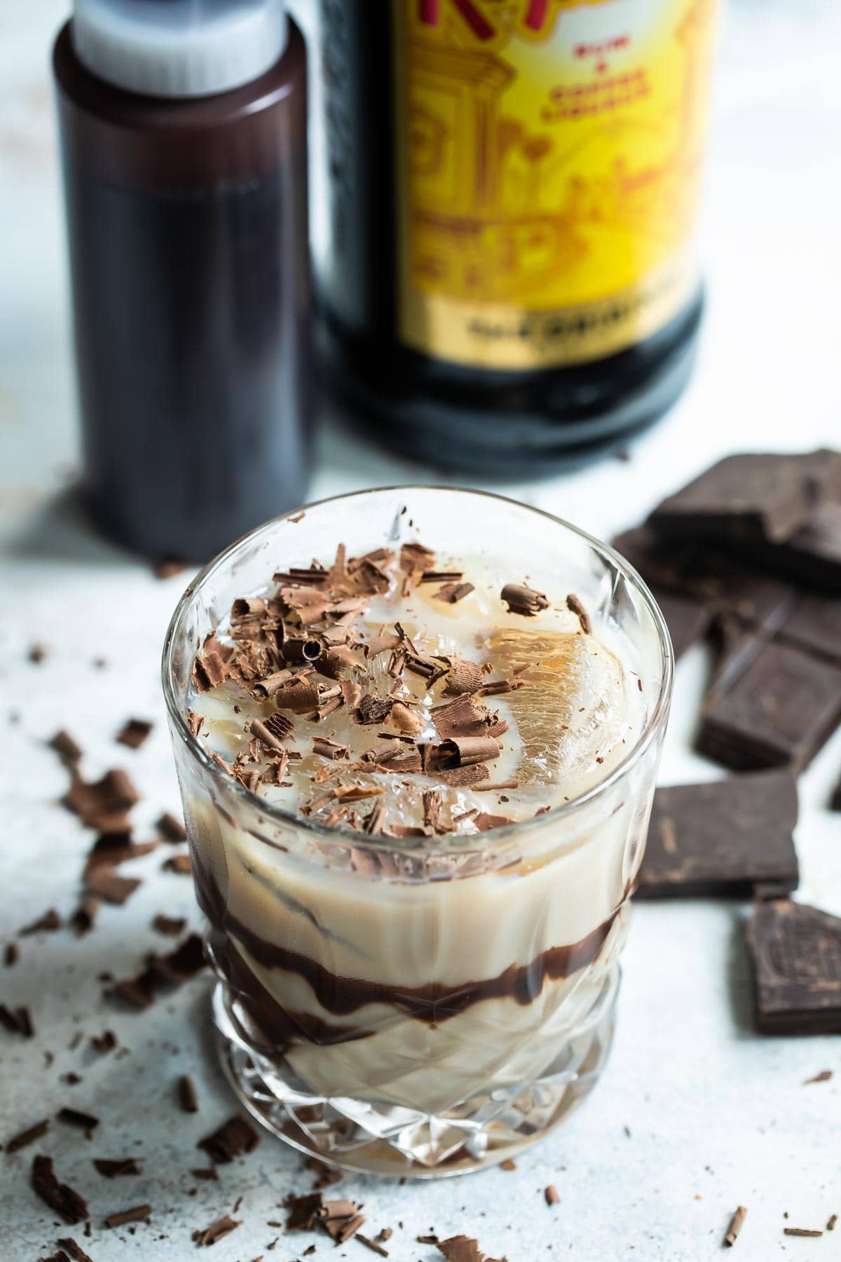 A mudslide cocktail with chocolate in the background.