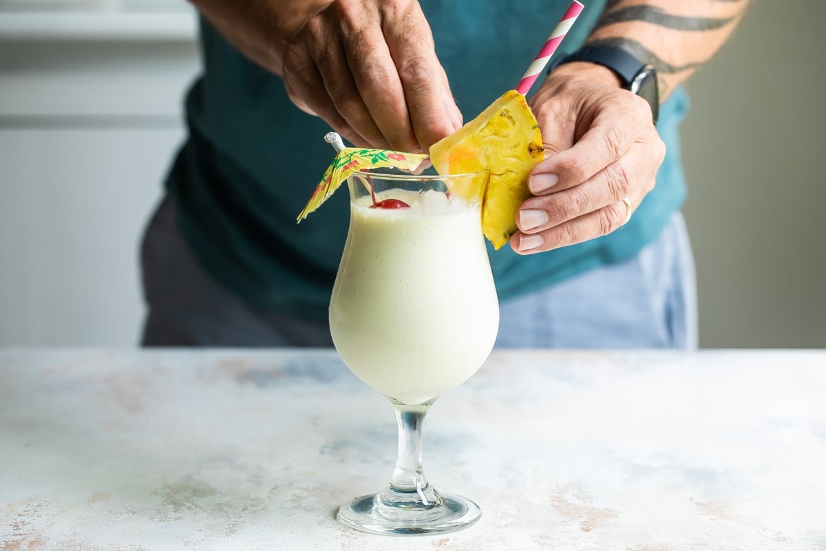 Building a piña colada in a hurricane glass.