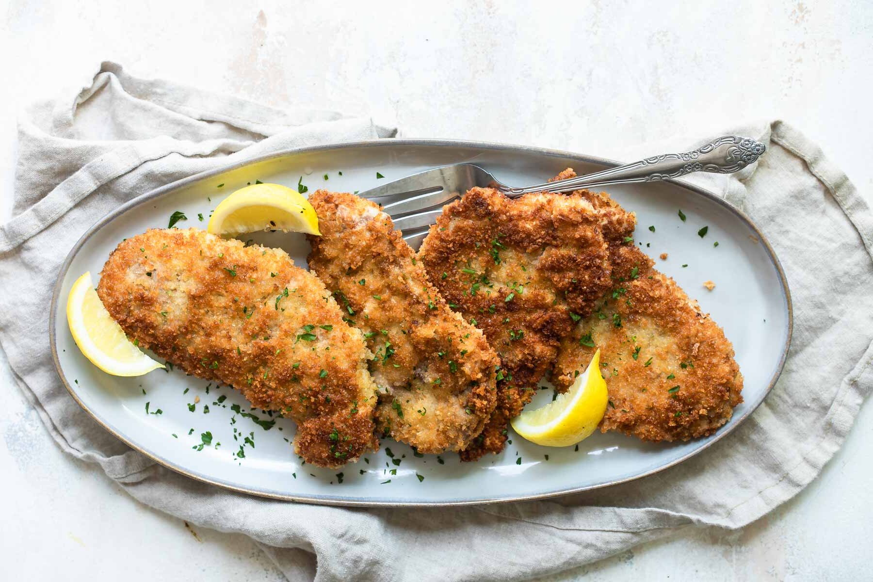 A platter of pork schnitzel.