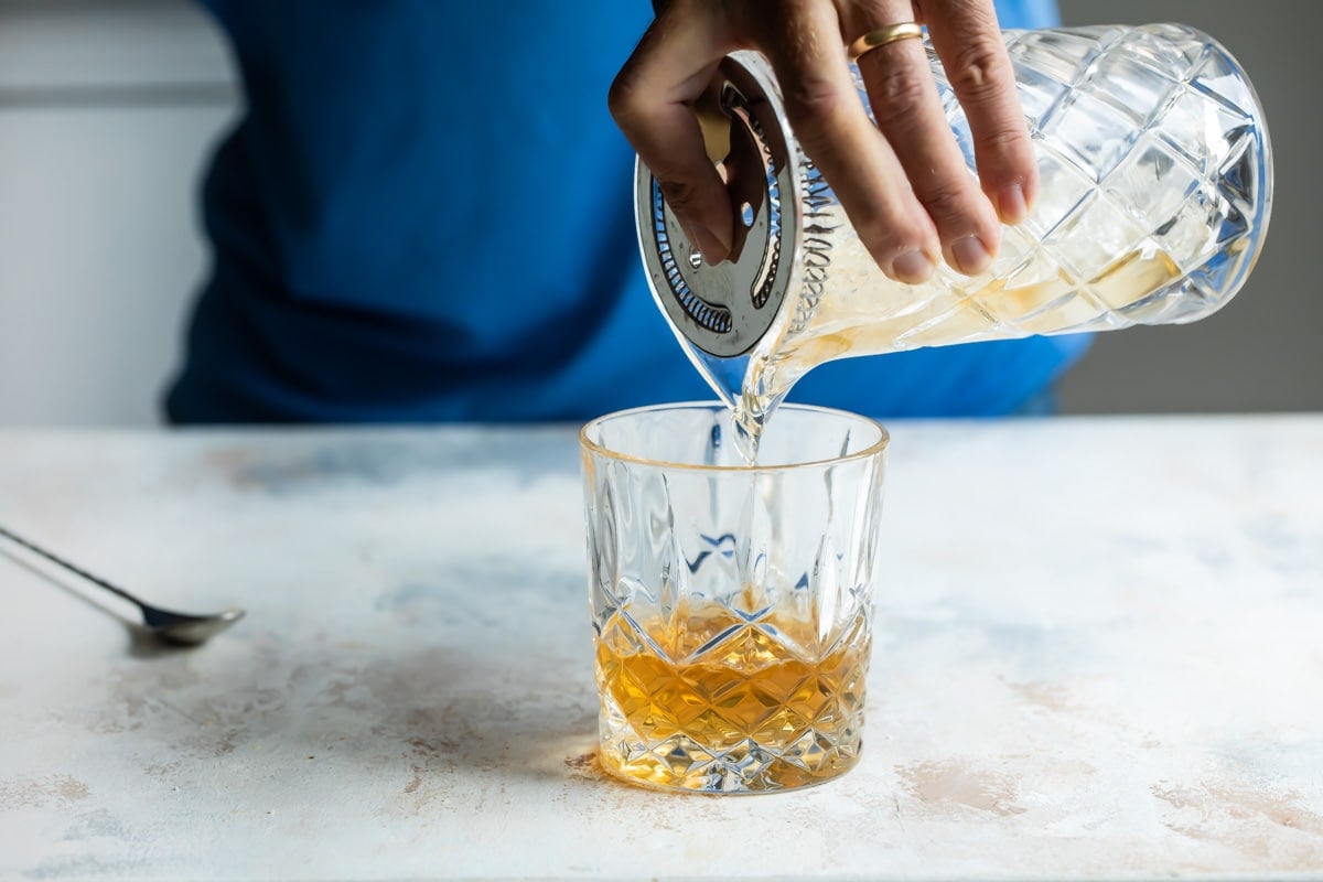 Mixing a Sazerac in a lowball glass.