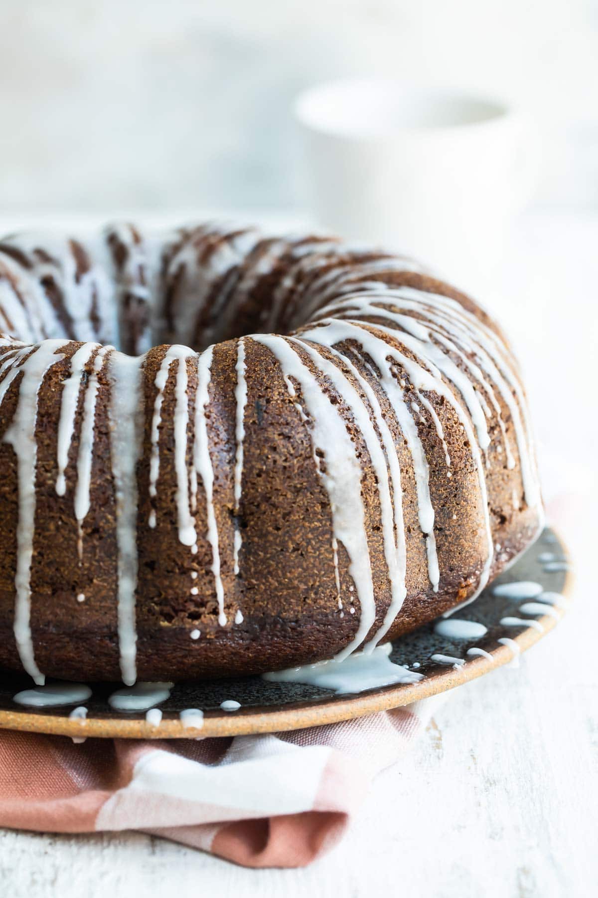 A round spice cake with drizzled icing.