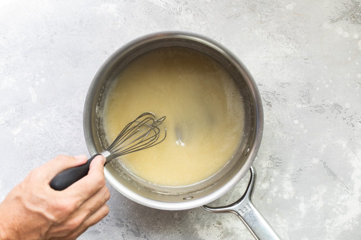 Flour and butter cooking in a silver pot.