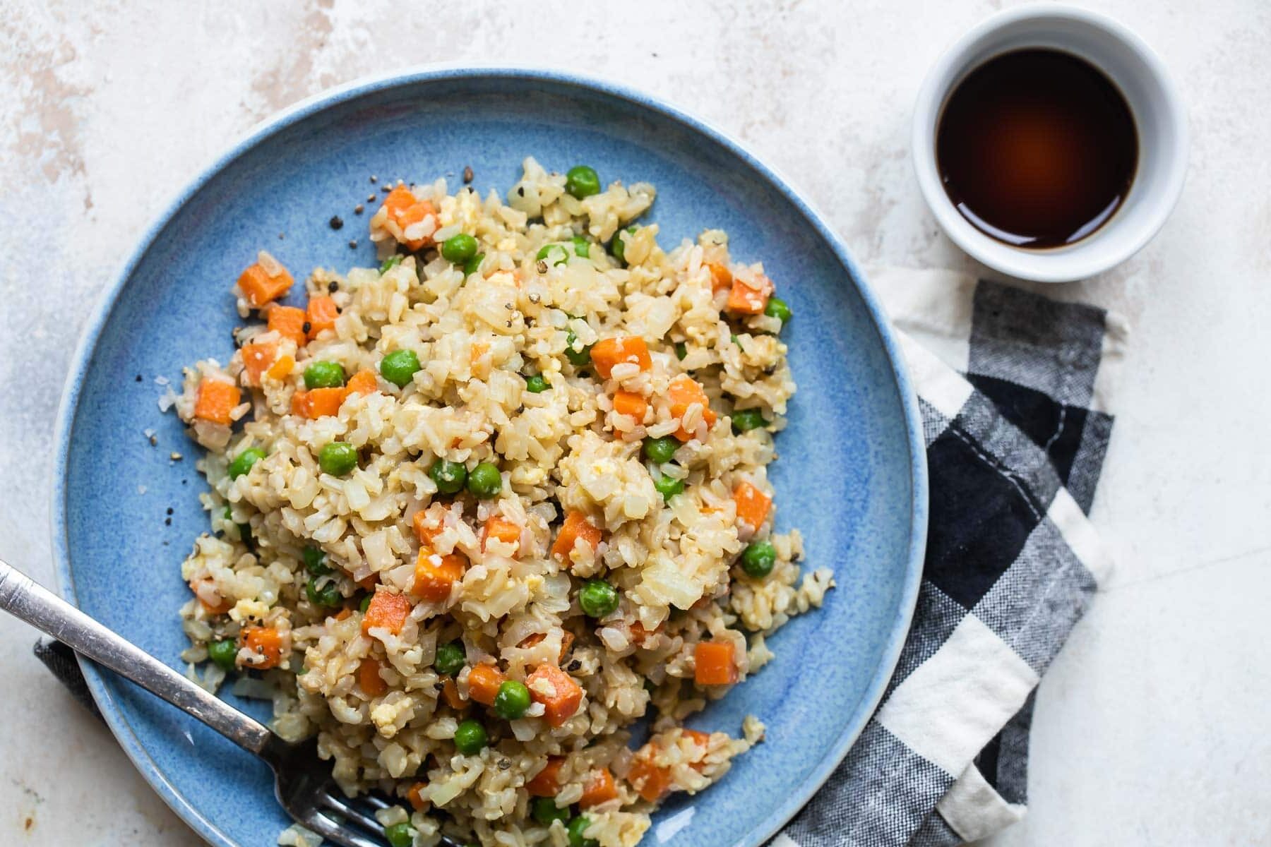 Brown fried rice on a blue plate.