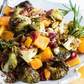 A serving of harvest roasted vegetables on a white plate.