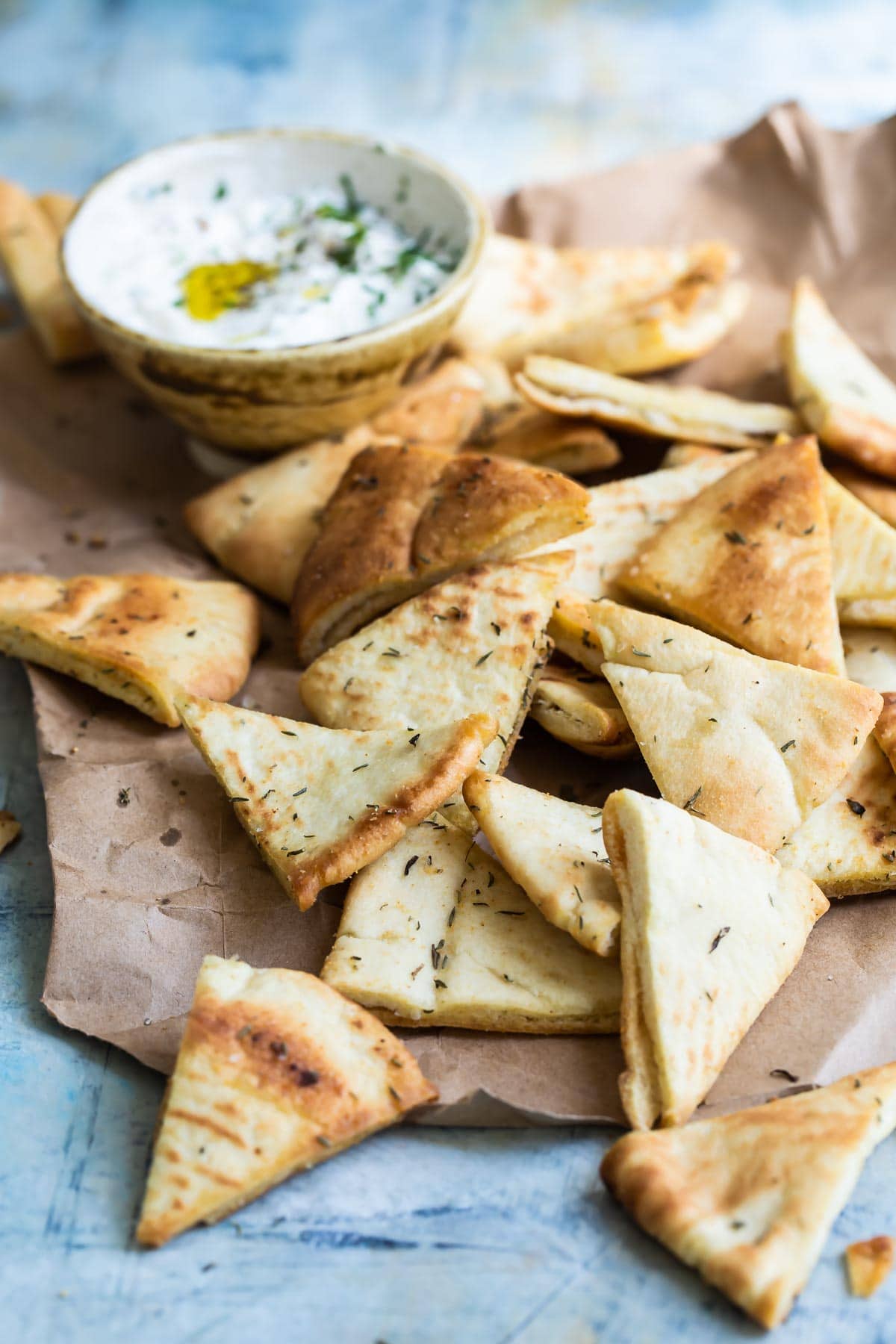 Homemade pita chips with a bowl of hummus.