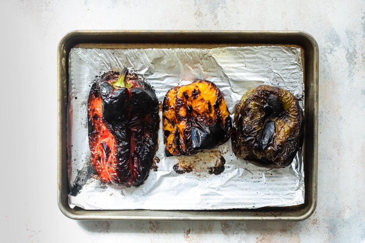 Roasted peppers on a baking sheet.