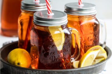 Glass mugs of iced tea on a tray.