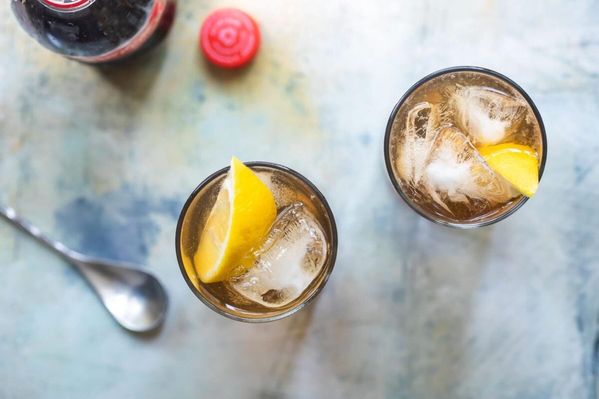 Two highball glasses of long island iced tea.