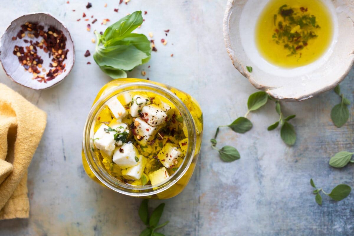 Marinated feta in a clear jar.