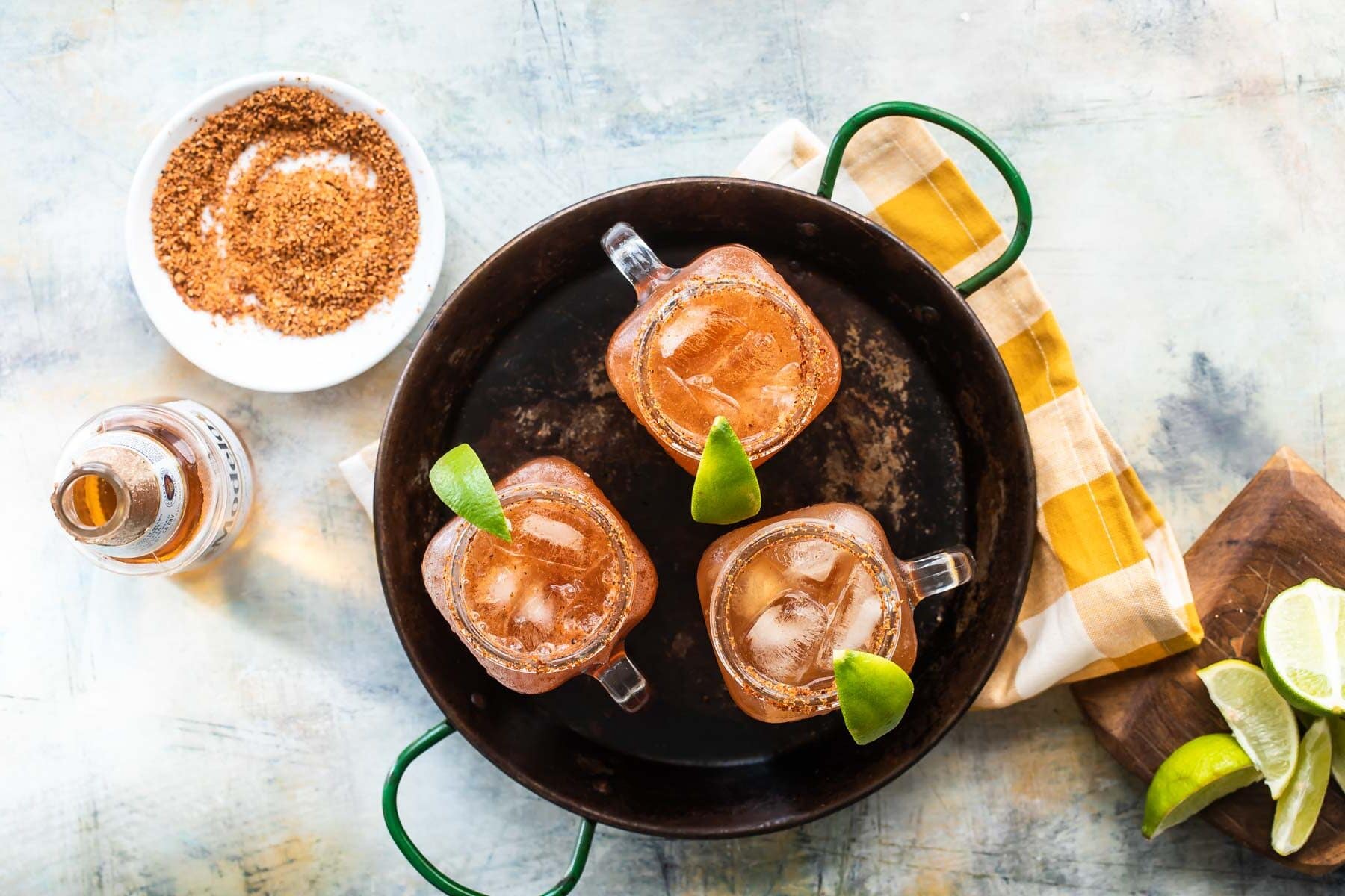 3 Micheladas on a metal tray.
