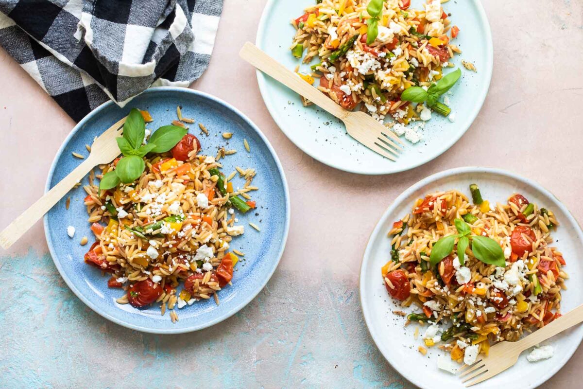 Orzo pasta salad on 3 plates.