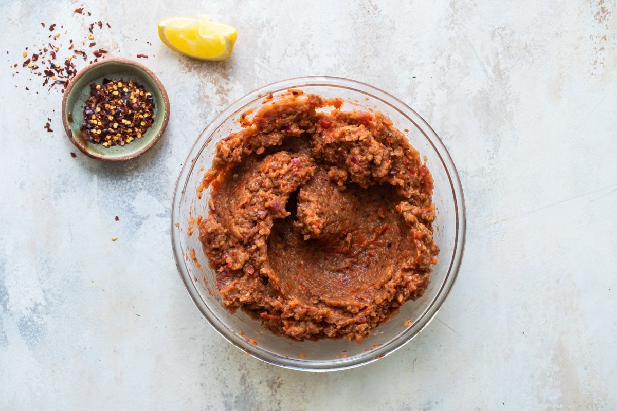 Roasted eggplant dip in a clear bowl.