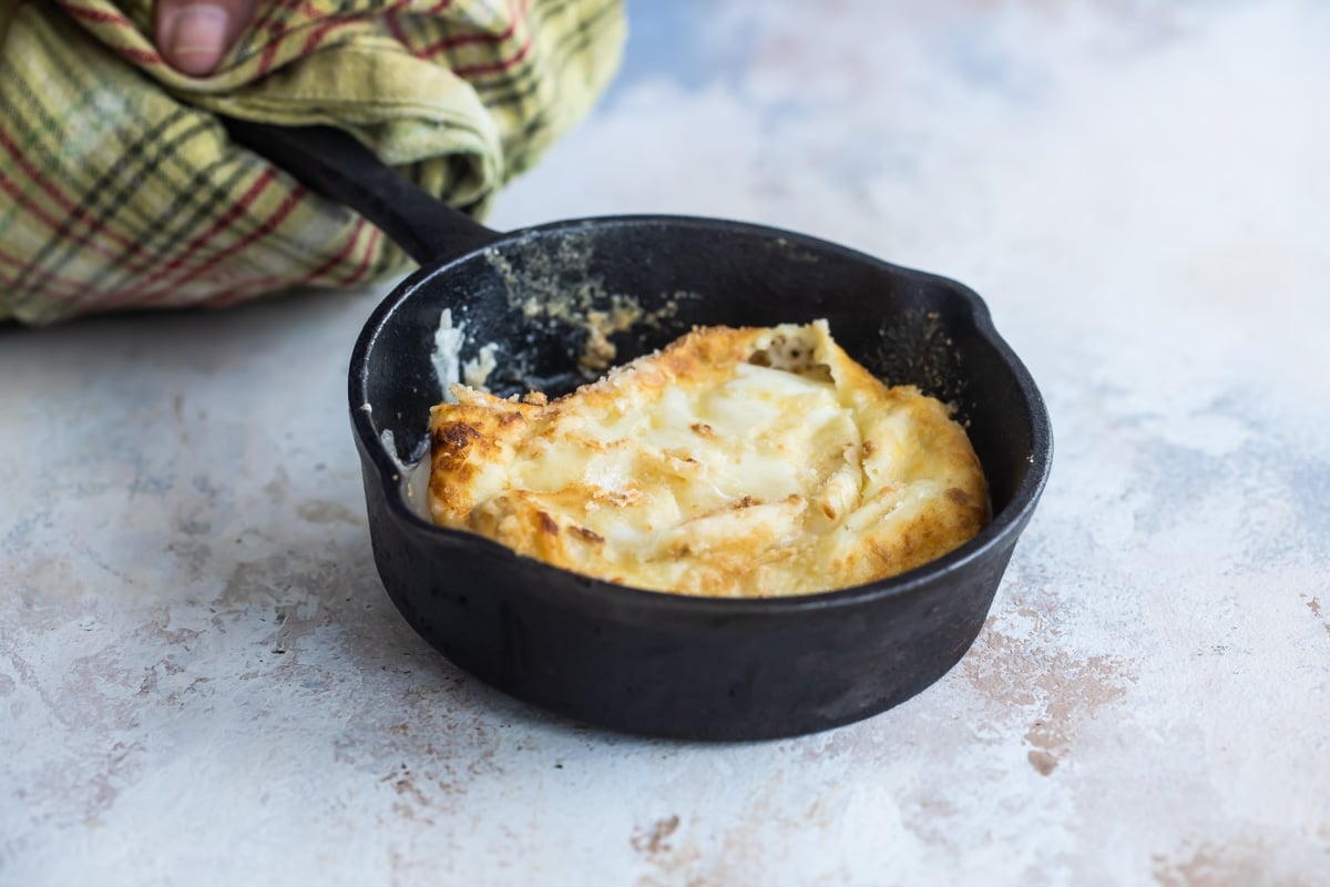 Saganaki in a small cast iron pan.