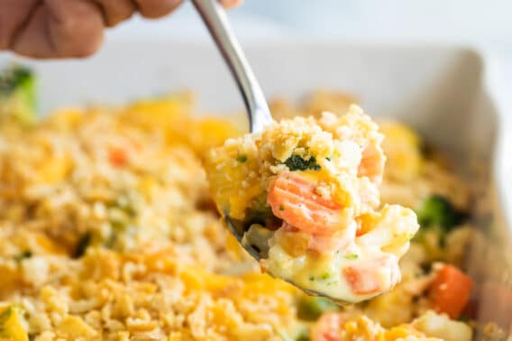 A pan of vegetable casserole with Velveeta and cracker crumbs.