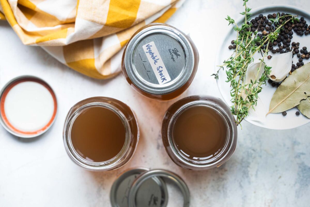Labeled vegetable stock in mason jars.