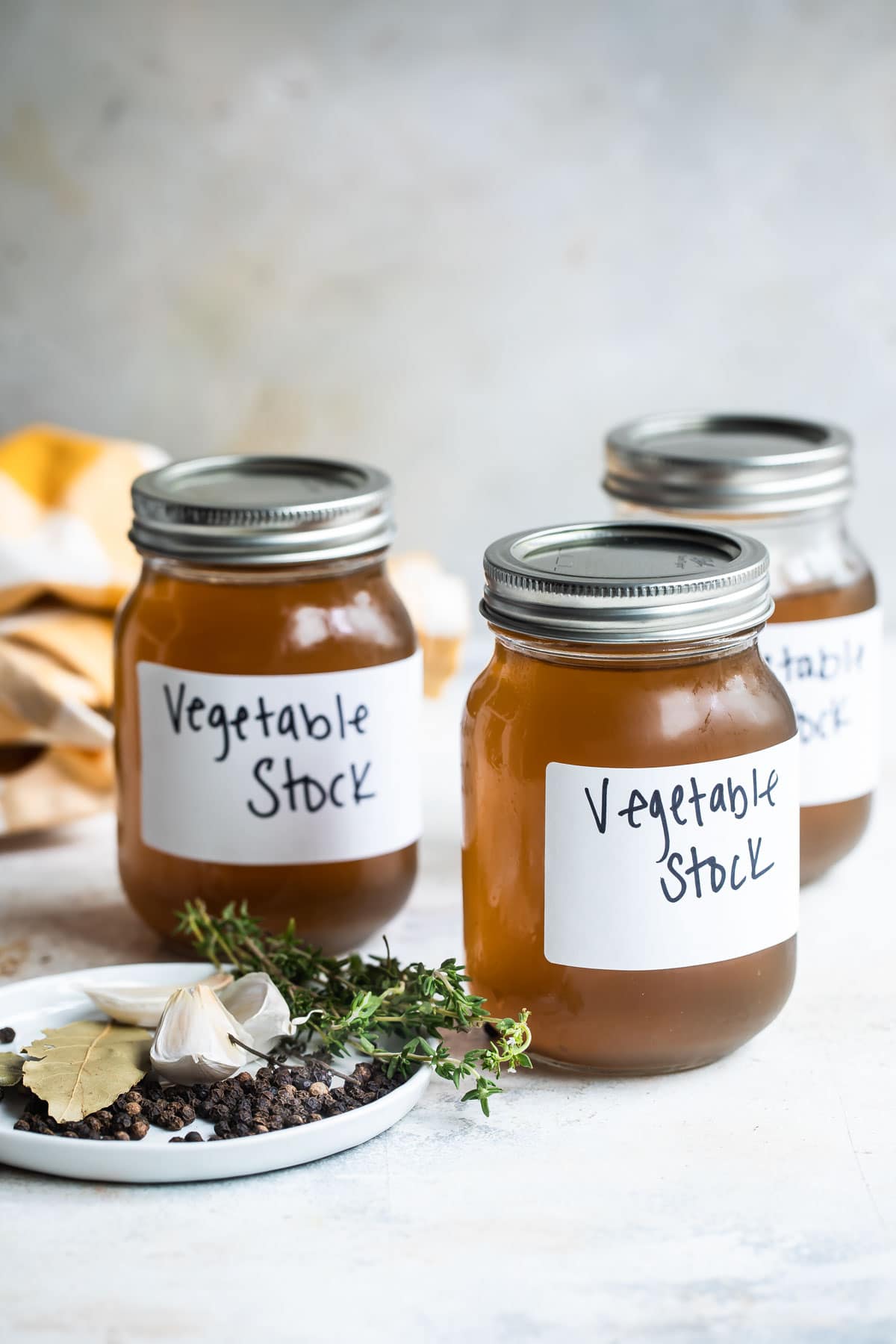 Labeled vegetable stock in mason jars.