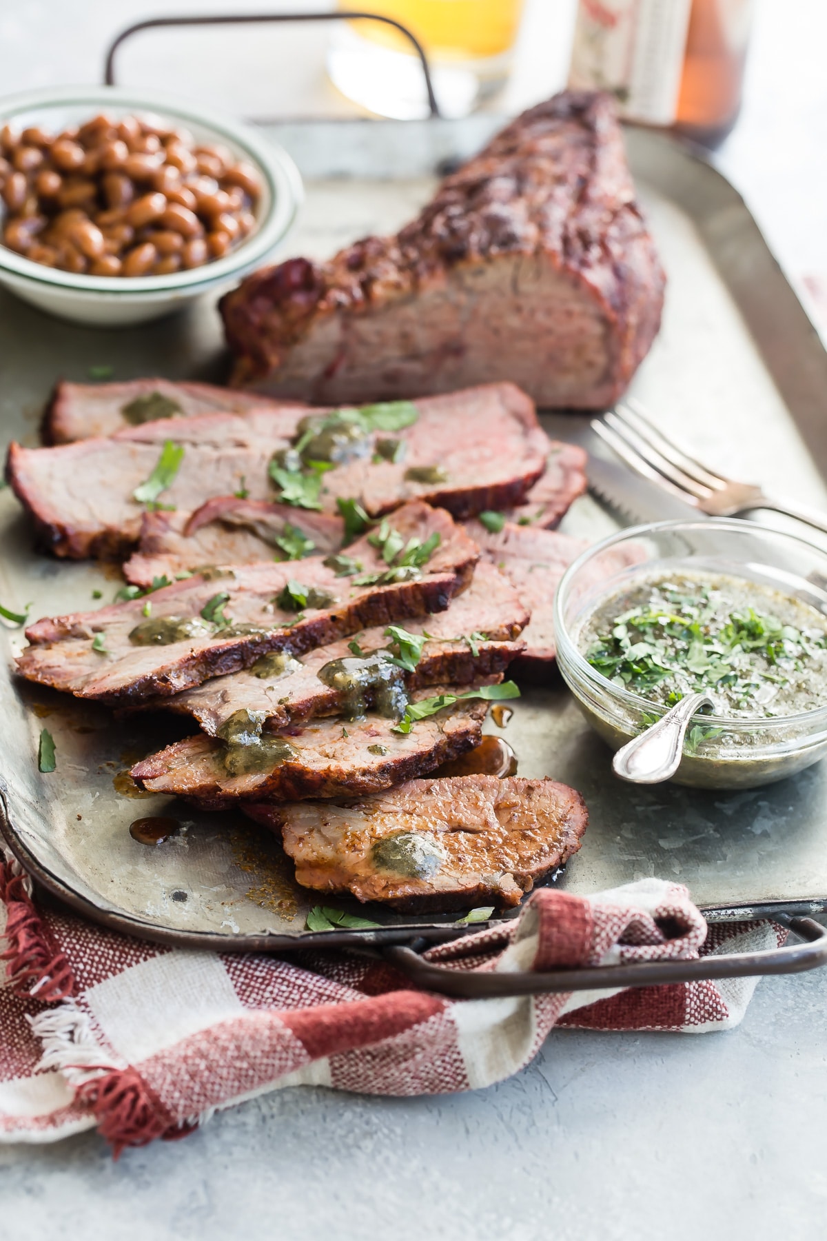 Tri-tip slices on a metal serving tray.