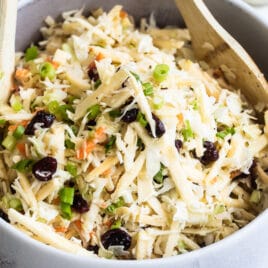 A serving bowl filled with apple coleslaw.