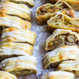 Two apple strudels on a baking sheet.