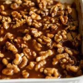 Apple walnut cobbler in a white baking dish.