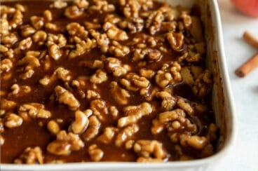 Apple walnut cobbler in a white baking dish.