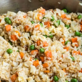 Brown fried rice in a silver skillet.