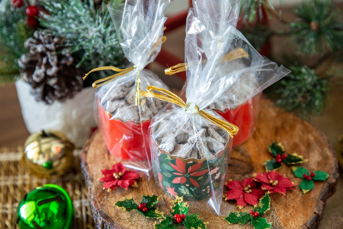 3 small containers of puppy chow wrapped for Christmas.