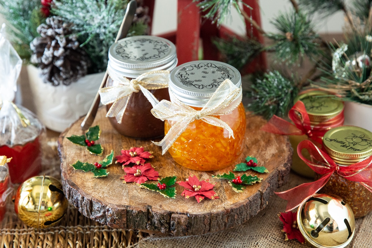Jars of orange marmalade and apple butter wrapped for Christmas.