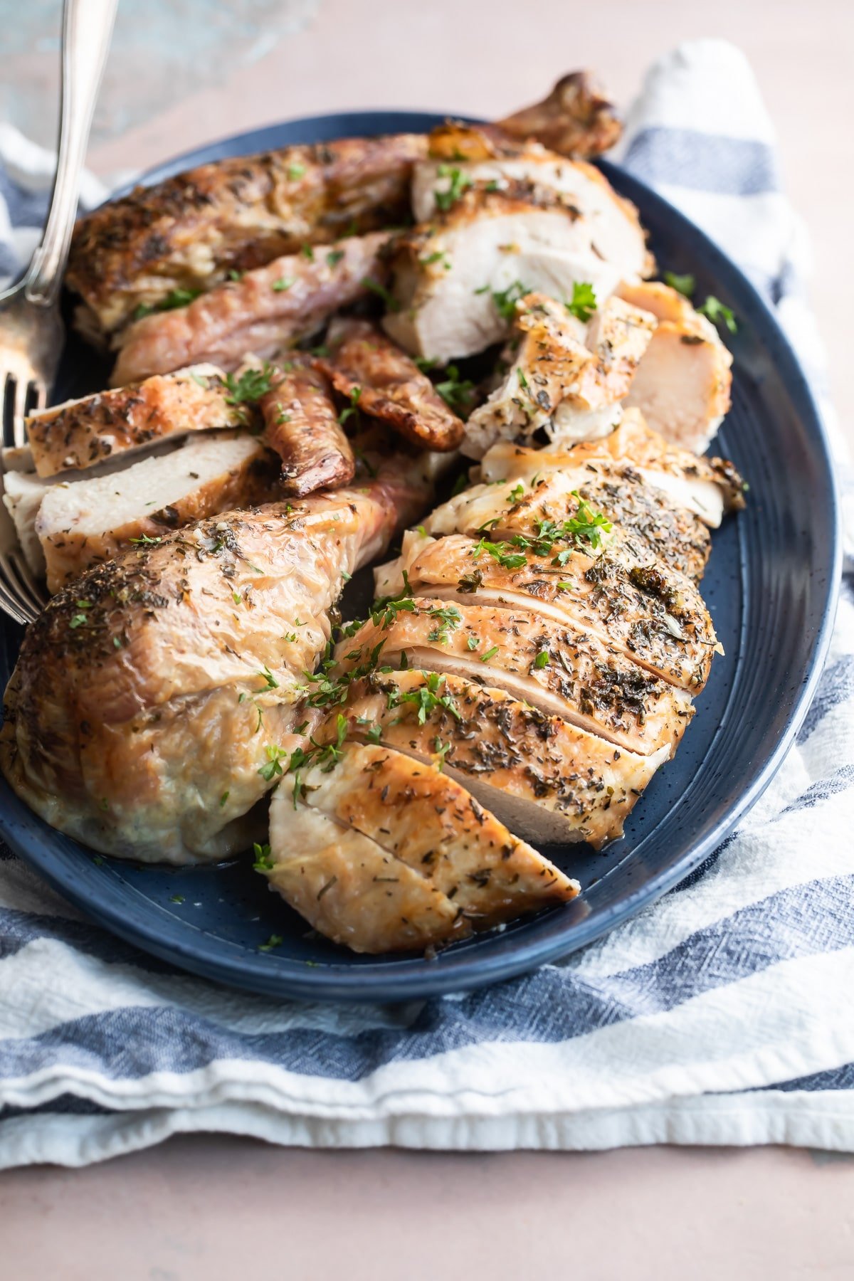 Make ahead roasted turkey on a blue platter.